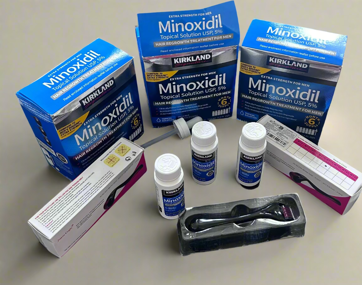 Kirkland Minoxidil packaging and bottles on a dark surface